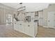 Modern kitchen with a large center island, stainless steel appliances, white cabinetry, and open access to the living area at 1950 Stethem Fry, Alpharetta, GA 30022
