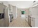 Contemporary kitchen boasts stainless steel appliances, center island with sink, modern countertops and new flooring at 1950 Stethem Fry, Alpharetta, GA 30022