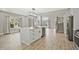 Bright kitchen featuring a large island, stainless steel appliances, and views of the living area and staircase at 1950 Stethem Fry, Alpharetta, GA 30022