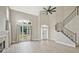 Inviting living room featuring large windows, a cozy fireplace, modern flooring, and access to a staircase at 1950 Stethem Fry, Alpharetta, GA 30022