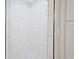Close-up of the tiled shower with pebble floor and seamless glass door at 1950 Stethem Fry, Alpharetta, GA 30022