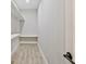 Clean walk-in closet with wood grain floor, built-in shelving, and hanging rod at 1950 Stethem Fry, Alpharetta, GA 30022