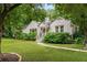 Charming white brick home with lush front yard, mature trees, and inviting walkway to entrance at 2119 Glenwood Se Ave, Atlanta, GA 30316
