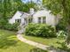 Charming white brick home with lush front yard, walkway to entrance, and mature trees at 2119 Glenwood Se Ave, Atlanta, GA 30316