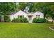 Charming white brick home with lush front yard and mature trees offers inviting curb appeal at 2119 Glenwood Se Ave, Atlanta, GA 30316