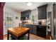 Bright kitchen featuring dark cabinets, stainless steel appliances, butcher block island, and easy outdoor access at 2119 Glenwood Se Ave, Atlanta, GA 30316