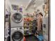 Functional laundry room with a stacked washer and dryer, organized shelving, and essential household storage solutions at 2119 Glenwood Se Ave, Atlanta, GA 30316