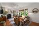 Bright living room featuring a fireplace, hardwood floors, and large windows at 2119 Glenwood Se Ave, Atlanta, GA 30316