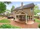 Large backyard with a covered patio, hot tub, mature trees, and a lush landscaped lawn at 2192 Nine Oaks Nw Dr, Kennesaw, GA 30152