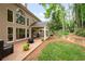 Spacious backyard features a covered patio, mature trees, a fire pit, and a beautifully landscaped yard at 2192 Nine Oaks Nw Dr, Kennesaw, GA 30152
