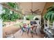 Outdoor patio with a large ceiling fan and an outdoor dining table and four chairs at 2192 Nine Oaks Nw Dr, Kennesaw, GA 30152