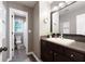 Well-appointed bathroom with dark vanity, modern fixtures, and a shower/tub combination in the background at 2192 Nine Oaks Nw Dr, Kennesaw, GA 30152