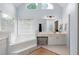 Bright bathroom showcasing a tub with steps, double vanity, and a charming vanity stool at 2192 Nine Oaks Nw Dr, Kennesaw, GA 30152