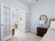 This is a partial view of a bedroom with a full bathroom just beyond the french doors at 2192 Nine Oaks Nw Dr, Kennesaw, GA 30152