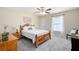 Cozy bedroom features a wooden bed frame, neutral carpet, and ample natural light from a window at 2192 Nine Oaks Nw Dr, Kennesaw, GA 30152