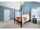 This is a well lit bedroom painted with blue colored walls and a four poster bed at 2192 Nine Oaks Nw Dr, Kennesaw, GA 30152
