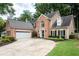 Attractive two-story brick and tan home with a wide driveway and attached two-car garage at 2192 Nine Oaks Nw Dr, Kennesaw, GA 30152