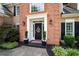 Close-up of home's front door shows well-kept landscaping, plants, and a brick facade at 2192 Nine Oaks Nw Dr, Kennesaw, GA 30152