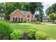 Charming brick home with a manicured lawn and mature trees that add to the home's curb appeal at 2192 Nine Oaks Nw Dr, Kennesaw, GA 30152