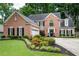 Charming brick home featuring manicured landscaping, black shutters, and a well-maintained lawn at 2192 Nine Oaks Nw Dr, Kennesaw, GA 30152