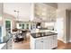 Open kitchen design with island, granite countertops, and white cabinetry, open to breakfast and living areas at 2192 Nine Oaks Nw Dr, Kennesaw, GA 30152