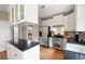 Well-lit kitchen featuring stainless steel appliances, granite countertops, and white cabinetry at 2192 Nine Oaks Nw Dr, Kennesaw, GA 30152