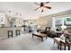 Spacious living room with an open layout, plush carpet, and natural light leading into the kitchen at 2192 Nine Oaks Nw Dr, Kennesaw, GA 30152