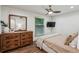 Cozy bedroom with hardwood floors, a ceiling fan, and a rustic wood dresser with a large mirror at 3650 Ashford Dunwoody Ne Rd # 811, Atlanta, GA 30319