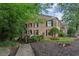 A lush landscape surrounds this quaint brick exterior featuring dark shutters and a cozy second-story balcony at 3650 Ashford Dunwoody Ne Rd # 811, Atlanta, GA 30319