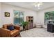 Inviting home office with hardwood floors, two windows, a comfortable chair and storage, perfect for work and relaxation at 3650 Ashford Dunwoody Ne Rd # 811, Atlanta, GA 30319