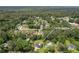 Aerial view of a home surrounded by mature trees and a well-maintained lawn in a desirable neighborhood at 1433 Janice Sw Ct, Lilburn, GA 30047