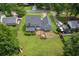 Aerial view of a house with a large backyard featuring a deck, mature trees and a private setting at 1433 Janice Sw Ct, Lilburn, GA 30047