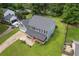 Aerial view of a two story home with a gray roof and siding, green lawn, covered porch, and a two car attached garage at 1433 Janice Sw Ct, Lilburn, GA 30047