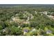 Aerial view showing a home surrounded by mature trees and a well-maintained lawn in a desirable neighborhood at 1433 Janice Sw Ct, Lilburn, GA 30047
