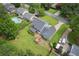 Aerial view of a two story home with a backyard deck and patio, green lawn, and a long driveway at 1433 Janice Sw Ct, Lilburn, GA 30047
