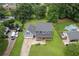 Aerial view of a two story home with a large, green lawn, a pool, a covered porch, and a two car attached garage at 1433 Janice Sw Ct, Lilburn, GA 30047