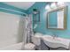 Bright bathroom featuring a tub with shower, toilet, and a decorative vanity mirror at 1433 Janice Sw Ct, Lilburn, GA 30047