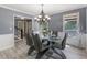 Dining room with a modern chandelier, table and chairs at 1433 Janice Sw Ct, Lilburn, GA 30047