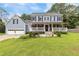 Charming two-story home with a covered front porch, attached garage, and well-maintained lawn at 1433 Janice Sw Ct, Lilburn, GA 30047