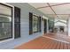 Spacious covered porch with wood flooring, outdoor seating, and a grill at 1433 Janice Sw Ct, Lilburn, GA 30047