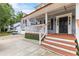 Inviting front porch with wooden steps, decorative front door, and classic exterior lighting at 1433 Janice Sw Ct, Lilburn, GA 30047