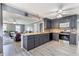 Well-lit open kitchen with stainless steel appliances and grey cabinets at 1433 Janice Sw Ct, Lilburn, GA 30047