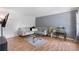 Bright living room with hardwood floors, a stylish couch and an aquarium at 1433 Janice Sw Ct, Lilburn, GA 30047