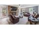 Cozy living room featuring a fireplace with brick surround, plush seating, and lots of natural light at 1433 Janice Sw Ct, Lilburn, GA 30047