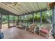 Sunroom with screened windows, ceiling fan, brick floor, and furniture at 1433 Janice Sw Ct, Lilburn, GA 30047