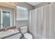 Bright bathroom showcasing a granite-look vanity and a shower featuring a shower curtain and window at 217 Odyssey Turn, Conyers, GA 30012