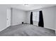 Bedroom with plush carpeting, neutral walls, and a large window at 217 Odyssey Turn, Conyers, GA 30012