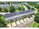 Rear view showcasing a row of townhomes with private patios, parking spaces, and well-kept landscaping at 217 Odyssey Turn, Conyers, GA 30012