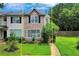 Charming townhome showcasing a well-manicured lawn and inviting facade with multi-pane windows allowing for natural light at 217 Odyssey Turn, Conyers, GA 30012