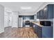 Well-lit kitchen features stainless steel appliances, ample counter space, and modern dark cabinets at 217 Odyssey Turn, Conyers, GA 30012